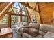 Comfortable living room features wood-paneled A-frame ceiling, large windows, and modern furnishings at 4205 Mont Blanc Way, Las Vegas, NV 89124