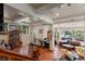 Inviting living area with hardwood floors, exposed beams, large windows, and a dining table at 4205 Mont Blanc Way, Las Vegas, NV 89124