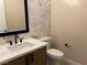 Elegant bathroom with marble tile and modern vanity at 5569 Artex Ave, Las Vegas, NV 89139