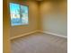 Well-lit bedroom featuring neutral walls and carpet at 5569 Artex Ave, Las Vegas, NV 89139