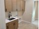 Laundry room with modern cabinets and utility sink at 5569 Artex Ave, Las Vegas, NV 89139