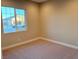 Bright bedroom featuring a large window and carpet flooring at 9207 Sandula Ct, Las Vegas, NV 89139