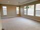 Large living room with multiple windows and carpet at 9207 Sandula Ct, Las Vegas, NV 89139