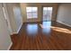 Spacious living room featuring wood floors, natural light, and seamless access to outdoor spaces at 6020 Genovese Ave, Las Vegas, NV 89141