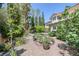 Picturesque backyard featuring a garden, lush landscaping, and a charming patio area, perfect for relaxation at 3179 Surf Spray St, Las Vegas, NV 89117