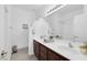Bathroom with dual sinks, chocolate vanity cabinets, and a large mirror at 3179 Surf Spray St, Las Vegas, NV 89117