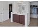 Bathroom vanity with chocolate cabinets, white countertops, and a large mirror, with closet access on either side at 3179 Surf Spray St, Las Vegas, NV 89117