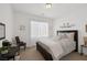 A cozy bedroom featuring a queen-size bed, soft neutral bedding, and a decorative metal wall art piece at 3179 Surf Spray St, Las Vegas, NV 89117