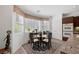Bright breakfast nook features a glass table, four chairs, and a large window with natural light at 3179 Surf Spray St, Las Vegas, NV 89117