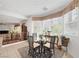Cozy breakfast nook features a glass table, four chairs, and a large window at 3179 Surf Spray St, Las Vegas, NV 89117