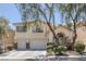 Charming two-story home with a well-manicured front yard and a two-car garage, framed by mature trees at 3179 Surf Spray St, Las Vegas, NV 89117