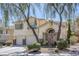 Charming two-story home with a well-manicured front yard and a two-car garage, framed by mature trees at 3179 Surf Spray St, Las Vegas, NV 89117
