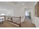 Bright hallway with carpet flooring and wood banister leading to bedrooms at 3179 Surf Spray St, Las Vegas, NV 89117