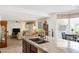 Open kitchen with granite countertops, stainless steel appliances, and breakfast bar at 3179 Surf Spray St, Las Vegas, NV 89117