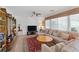 Living room area featuring a sectional couch, large window, and built-in shelving at 3179 Surf Spray St, Las Vegas, NV 89117