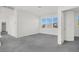 Bright bedroom with grey carpet and large windows at 8010 Arcadian Ln, Las Vegas, NV 89147