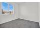 Simple bedroom with grey carpet and large window at 8010 Arcadian Ln, Las Vegas, NV 89147