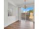 Dining room with hardwood floors and sliding glass doors to patio at 8010 Arcadian Ln, Las Vegas, NV 89147