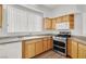 Kitchen with wood cabinets, granite countertops, and stainless steel appliances at 8010 Arcadian Ln, Las Vegas, NV 89147