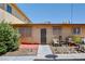 Tan exterior, small patio, and mature shrubbery at 3841 Daisy St # 18, Las Vegas, NV 89119