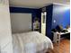 Modern bedroom with blue walls, hard floors, closet, desk, and natural light creates a serene atmosphere at , Pahrump, NV 89060