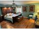 Charming bedroom featuring a decorative wood headboard, wood floors, and colorful accents for a cozy feel at , Pahrump, NV 89060