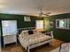 Bright bedroom with hard floors, white metal bed frame, and complementary white furniture for storage at , Pahrump, NV 89060