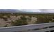 Vast desert scenery showcasing native shrubs, textures, and muted tones under a cloudy sky at , Pahrump, NV 89060
