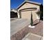 Tan house with a two-car garage and desert landscaping at 6072 Corbin Ave, Las Vegas, NV 89122