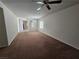 Spacious living room with brown carpet and ceiling fan at 6072 Corbin Ave, Las Vegas, NV 89122