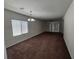 Spacious living room featuring neutral carpeting and a ceiling fan at 6072 Corbin Ave, Las Vegas, NV 89122