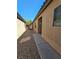 Side yard with gravel and walkway leading to the house entrance at 6072 Corbin Ave, Las Vegas, NV 89122