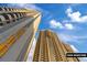 Exterior of the modern tall buildings under a bright blue sky at 135 E Harmon Ave # 1020, Las Vegas, NV 89109