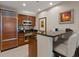 Modern kitchen with sleek appliances, a functional breakfast bar, and a warm color palette at 135 E Harmon Ave # 1020, Las Vegas, NV 89109