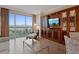 Bright living room with city views, large windows, and built-in entertainment center at 135 E Harmon Ave # 1020, Las Vegas, NV 89109