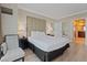 Well-lit main bedroom featuring a large bed, wood floors, and access to the main bath at 135 E Harmon Ave # 1020, Las Vegas, NV 89109