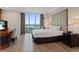Comfortable main bedroom with a large window and bright city view at 135 E Harmon Ave # 1020, Las Vegas, NV 89109