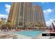 Stunning pool area with surrounding palm trees for relaxing with sun loungers and cabanas at 135 E Harmon Ave # 1020, Las Vegas, NV 89109