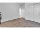 Bedroom featuring neutral carpet, closet with bi-fold doors, white walls, and passage to other rooms at 3558 E Malheur Ave, Pahrump, NV 89061