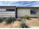 Exterior showcasing a secure gated entrance, desert landscaping, and a charming awning at 213 N Lamb Blvd # D, Las Vegas, NV 89110