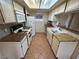 Narrow galley kitchen featuring white cabinetry, granite countertops and modern appliances offering a cozy cooking area at 213 N Lamb Blvd # D, Las Vegas, NV 89110