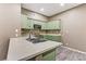 Bright kitchen features ample counter space, stainless steel sink, and light green cabinets at 5655 E Sahara Ave # 1052, Las Vegas, NV 89142