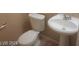 Simple bathroom with toilet and pedestal sink at 9229 Millikan Ave, Las Vegas, NV 89148