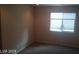 Bright bedroom with a window and neutral walls at 9229 Millikan Ave, Las Vegas, NV 89148