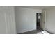 Simple bedroom with door to another room and laminate flooring at 9229 Millikan Ave, Las Vegas, NV 89148