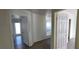 Clean hallway with doors to bedrooms and outside access at 9229 Millikan Ave, Las Vegas, NV 89148