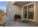 Private back patio with brick pavers, patio furniture, and sliding glass door to the home's interior at 10664 Sariah Skye Ave, Las Vegas, NV 89166