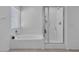 Bright bathroom showcasing a soaking tub with window and a separate glass-enclosed shower at 10664 Sariah Skye Ave, Las Vegas, NV 89166
