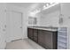 Bathroom featuring double sink vanity, large mirror, and tile flooring at 10664 Sariah Skye Ave, Las Vegas, NV 89166