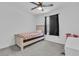 A bright bedroom with neutral color scheme, ceiling fan and carpet flooring at 10664 Sariah Skye Ave, Las Vegas, NV 89166